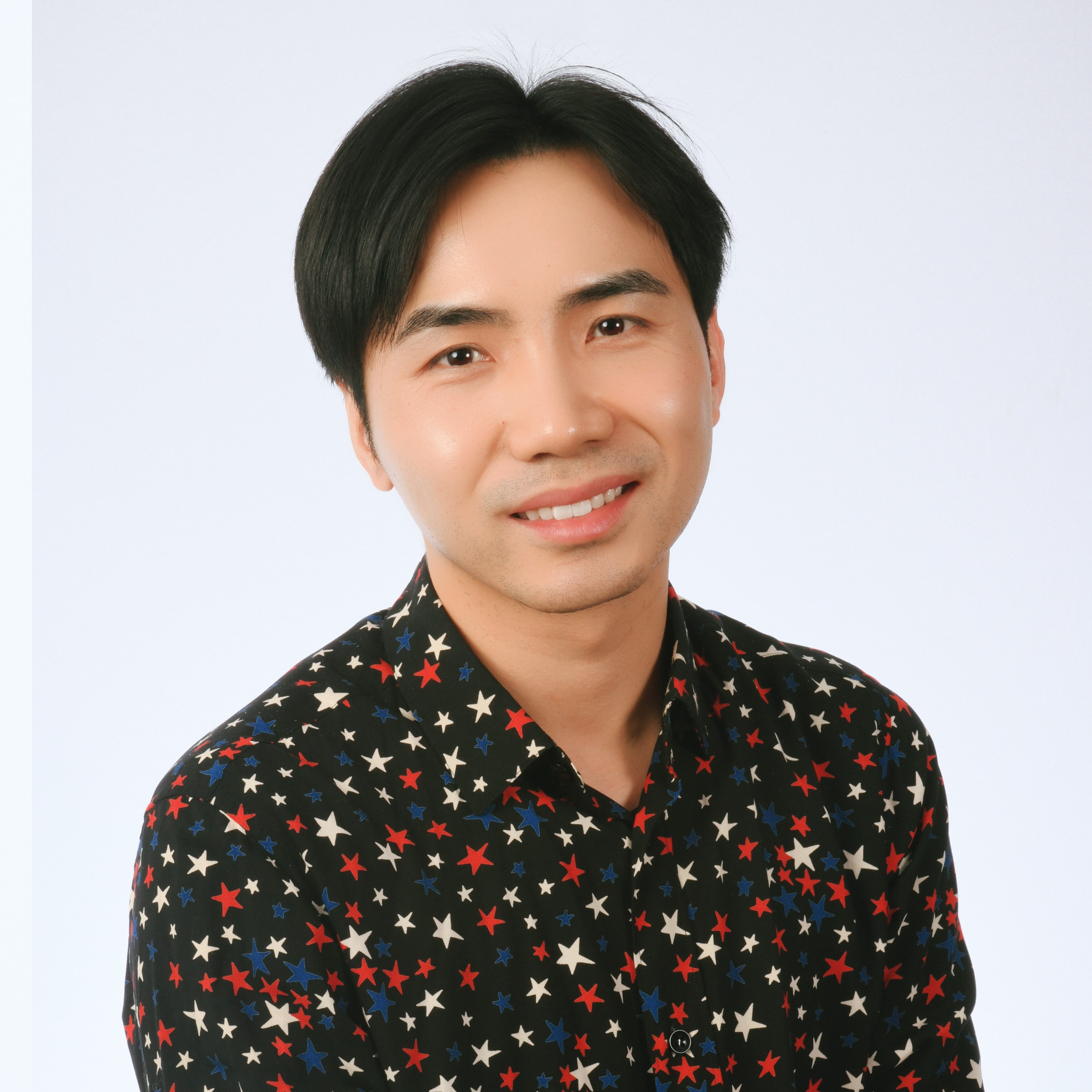 Corporate headshot — man in star-print shirt