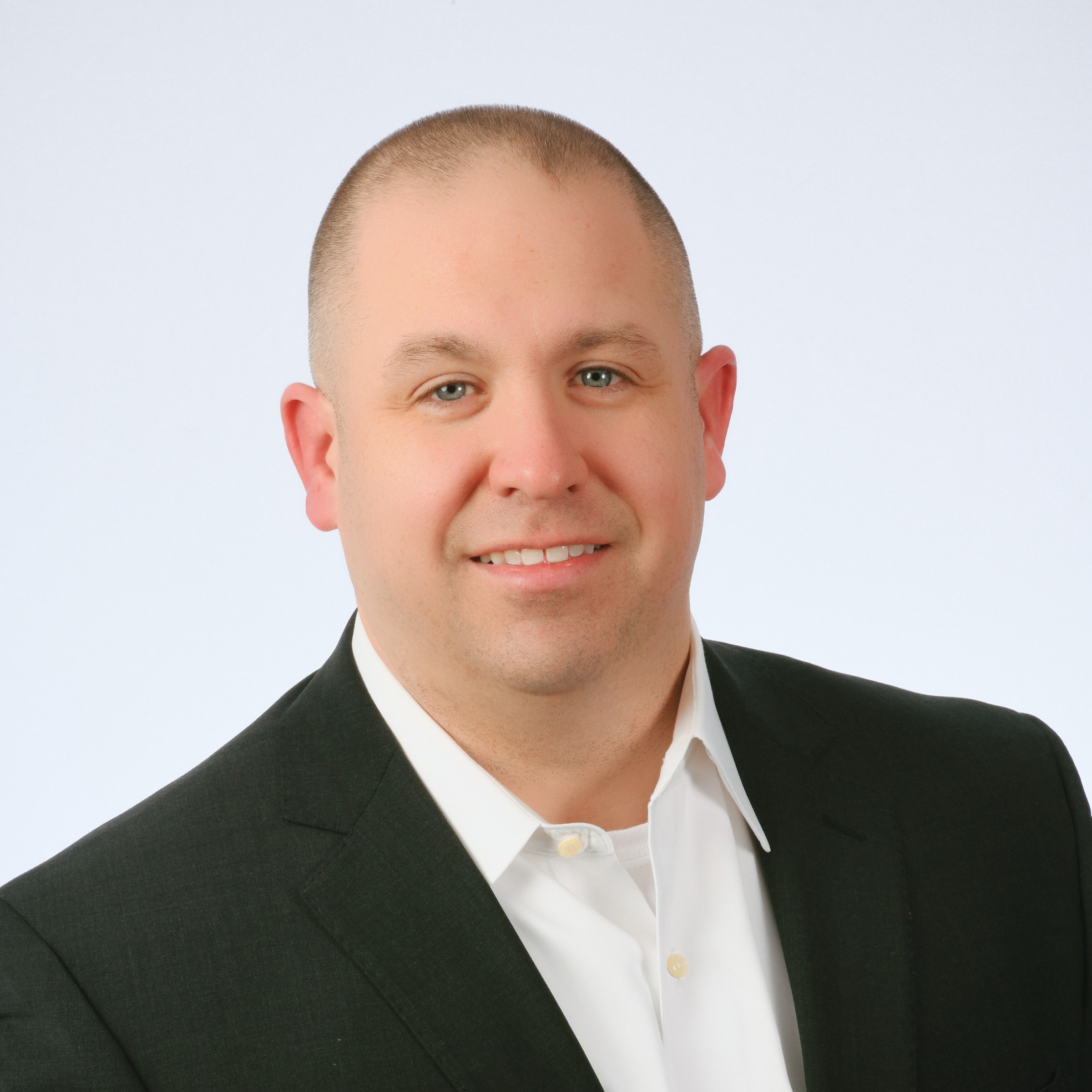 Corporate headshot — man in dark blazer