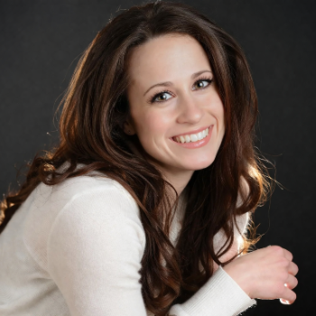 Corporate headshot — woman with long dark hair