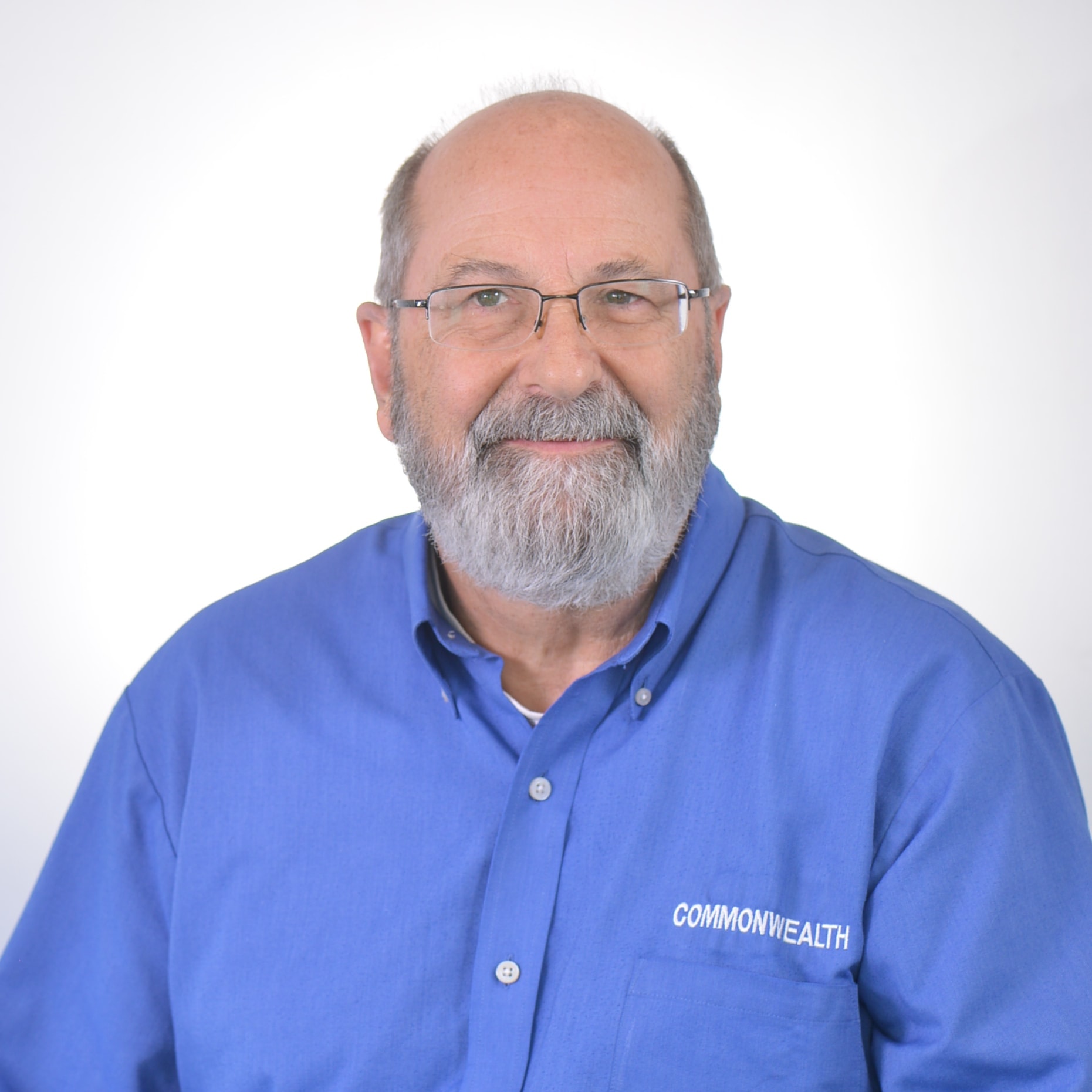 Corporate headshot — man in Commonwealth shirt