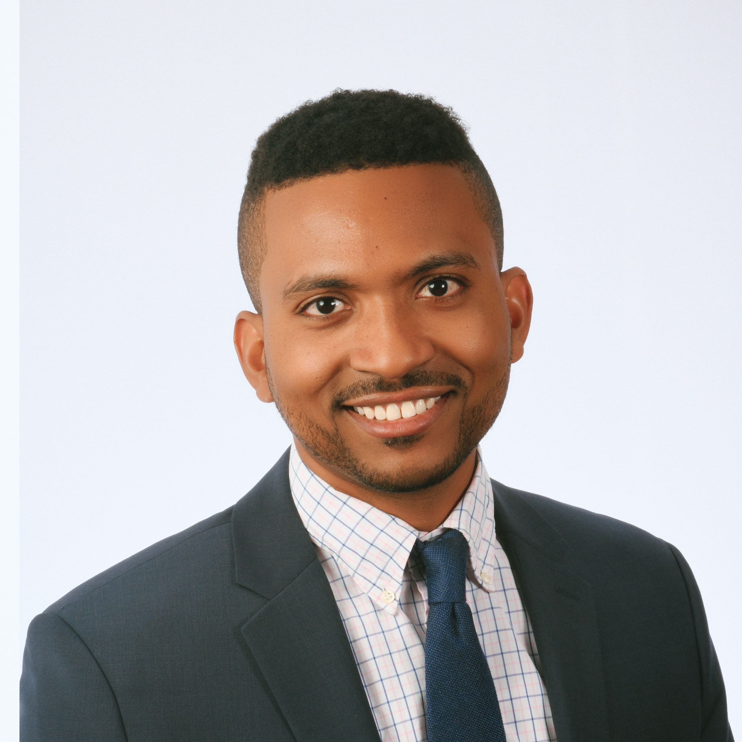 Professional headshot — man in black blazer